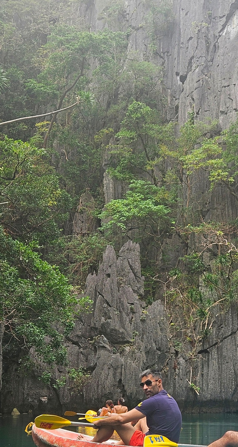 Dr Safdar Shah kayaking beneath limestone cliffs